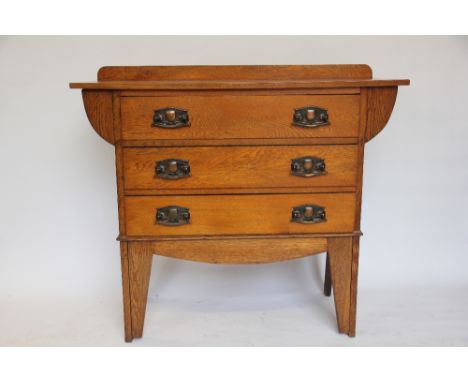 An Arts and Crafts oak chest, of three long drawers with Art Nouveau handles, on tall bracket feet, 97cm H x 107cm W x 42cm D