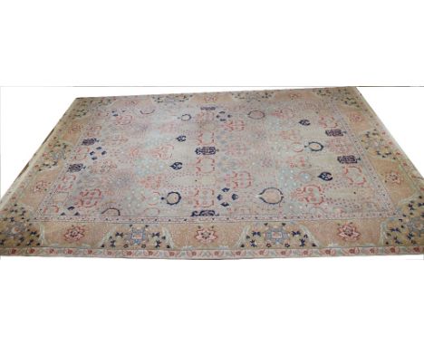 A Chinese Shantung carpet, worked with an all over floral design against a blue ground, 426cm x 300cm