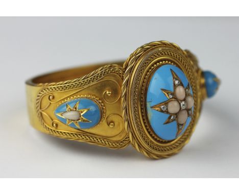A Victorian diamond, coral and turquoise enamelled hinged bangle, the central oval panel set with a star shaped design agains