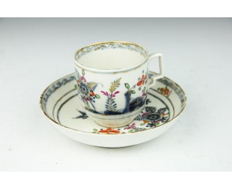 A Vienna cup and saucer, 18th century, decorated in underglaze blue with floral sprays and birds, overglaze polychrome enamel