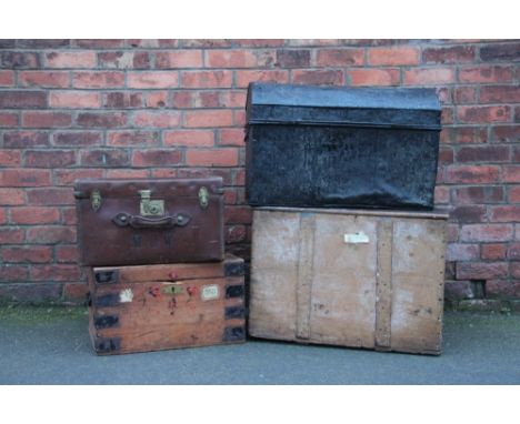 A metal trunk, three wooden trunks and a leather trunk