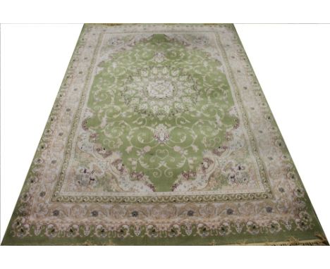 A machine woven Karol carpet, worked with a floral design against a green ground, 300cm x 200cm