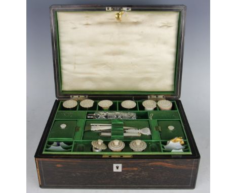 A Victorian work box, the Coromandel box with fitted green silk lined interior containing a selection of mother of pear spool