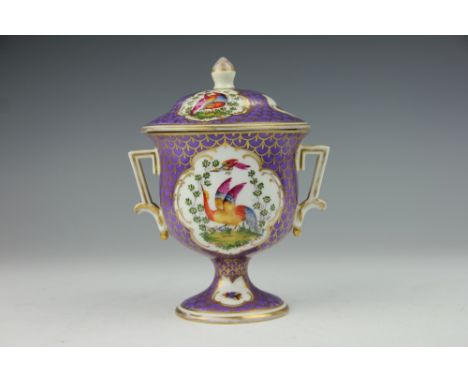 An English porcelain two handled cup and cover, 19th century, the pedestal cup decorated with reserves of exotic plumed birds