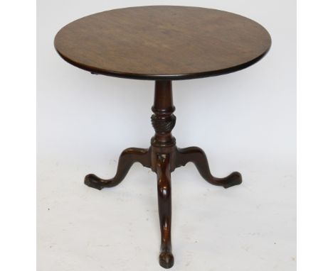 A George III mahogany tilt top occasional table, with single piece circular top, on a turned and spiral fluted column and tri