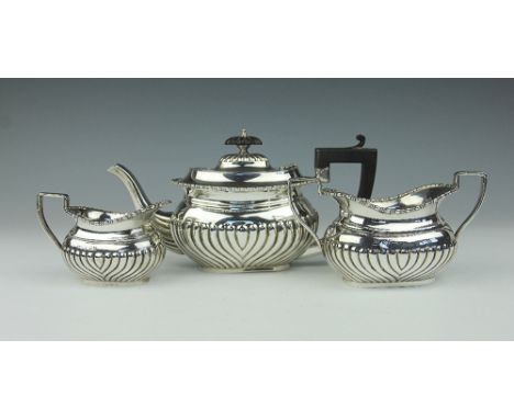 A three piece batchelors tea service, Fergenbaum & Son, Birmingham 1921, of half fluted form, comprising; teapot with ebonise