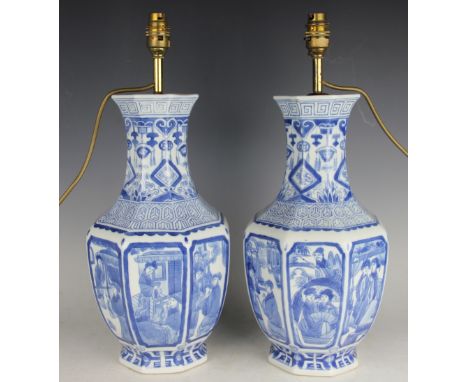 A pair of Chinese style octagonal baluster lamp bases, painted in blue with Chinese scenes, 47cm high including fittingsThese