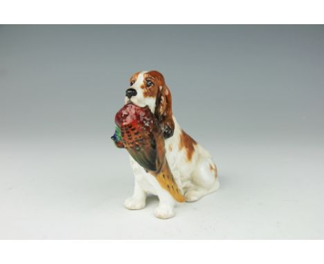 A Royal Doulton model of a seated spaniel with pheasant, HN1028, 14cm