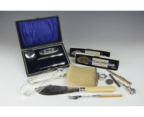 A collection of small silver wares, to include; two pairs of silver sugar nips, a silver pill box, two silver handled serving
