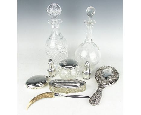 A collection of silver, to include; a silver snuff box initialled 'J.R.M', two silver mounted dressing table jars, a silver b