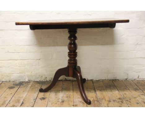 A George III mahogany occasional table, with rectangular top, on a turned column and tripod base, 71cm H x 90cm W x 63cm D