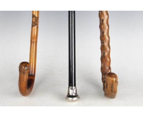 A silver mounted ebony walking cane, London 1922, with a carved wood walking stick, possibly Japanese, carved with skeletons,