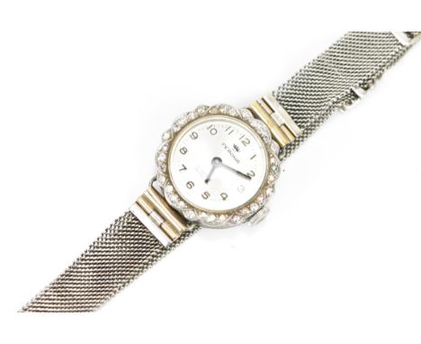 A mid 20th century white metal ladies manual wind diamond cocktail watch, the silvered dial having Arabic numerals surrounded