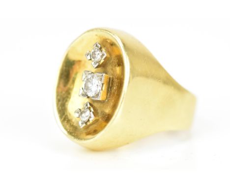 A yellow gold and three stone diamond dress ring, the central diamond 3.2mm diameter flanked by two 2mm diameter diamonds, in