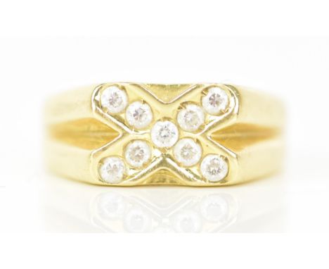 A yellow gold ring, inset with nine paste stones in a cross configuration, ring size T, testing as 14ct-18ct, 7.2 gramsIf the