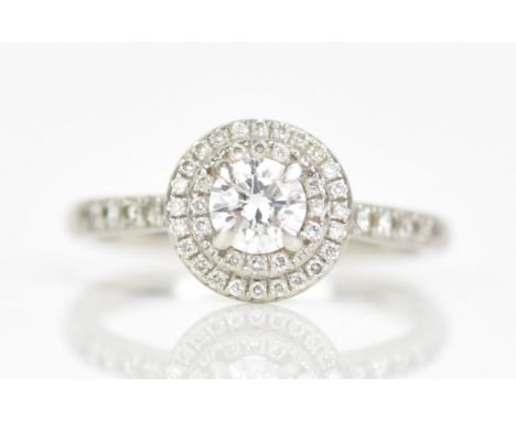 A platinum and diamond engagement ring, the round brilliant cut diamond weighing 0.46ct, colour D, clarity SI, mounted in a p