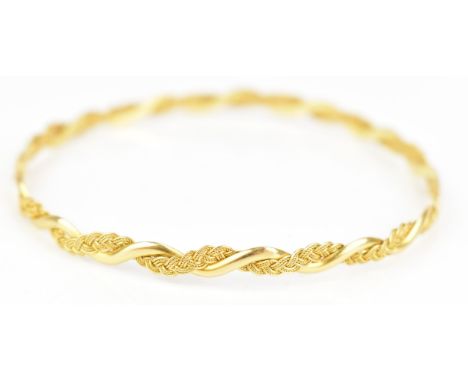 An 18ct yellow gold bangle, cast as an entwined spiga style chain, stamped 18ct, approx 20.4cm dinner diameter, 10.1 gramsIf 