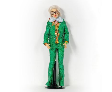In a custom Gucci green brocade ensemble and loafers with a medallion necklace.Height 12 inches (30.5 cm)Mattel debuted this 