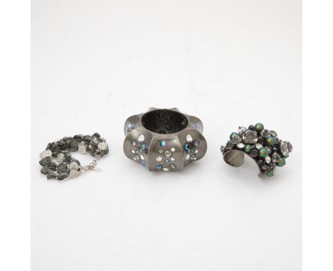 20th/21st centuryComprising a brushed metal and rhinestone bangle, a brushed metal and rhinestone cuff and a smokey faceted c