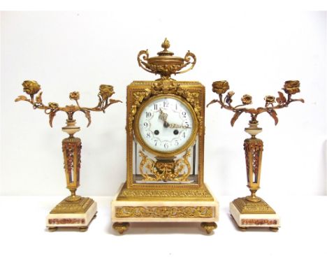 A 19TH CENTURY FRENCH GILT MANTEL CLOCK GARNITURE  the circular 11cm diameter convex white enamel dial with black Arabic nume
