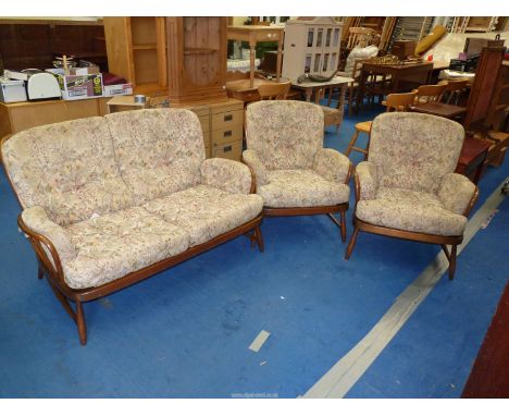 An Ercol two seater settee and two chairs.