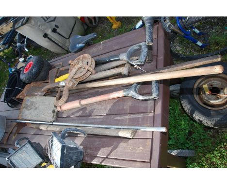 Axe, spades, cultivators and rope pulley.