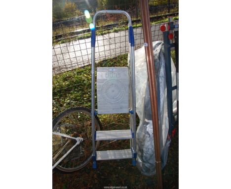 A three rung aluminum step ladder.