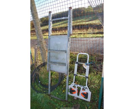 A small fold up sack truck and a step platform.