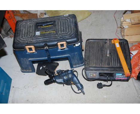 A tile cutter, a power station with 240 volt electric drill, knee pads extension leads etc.