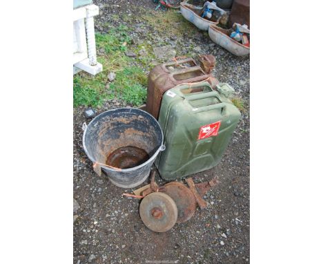 Two modern jerry cans, hand operated bench grinder, and galvanised bucket painted black.