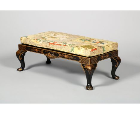 19th Century black lacquered foot stool, chinoiserie decoration, with a cane work seat, 75cm long 