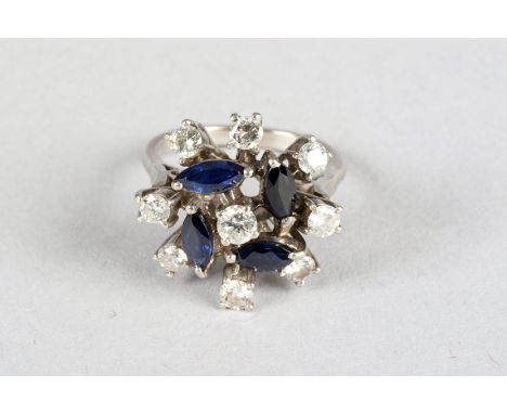 White gold sapphire and diamond cluster ring, a centre diamond with four marcasite cut sapphires surrounded by eight diamonds