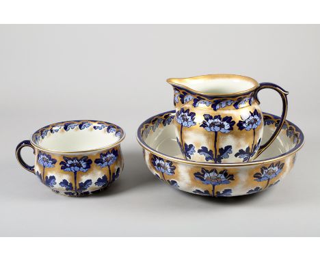 Three piece Losol ware wash stand set, basin, ewer and a bed pan, blue and white floral decoration with gilt enrichments, fac