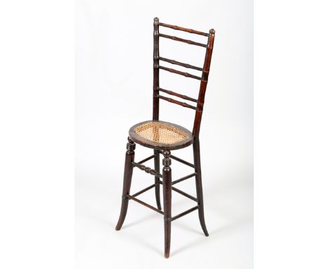 Childs high chair or correction chair to encourage good posture, cane seat, turned ladder back and supports 