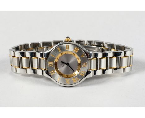 Boxed unisex stainless steel Cartier wrist watch, circular dial with gilt Roman numerals and a gilt minute ring, black hands,