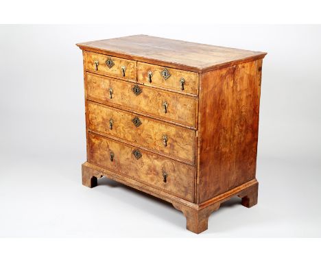 Georgian walnut two over three chest of drawers raised on bracket feet, cross banded top and drawer fronts. 102cm long x 56.5