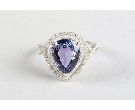 14K white gold and diamond ring set with a pear cut tanzanite. approx. 4 carats, diamond weight approx. 0.6 carats 