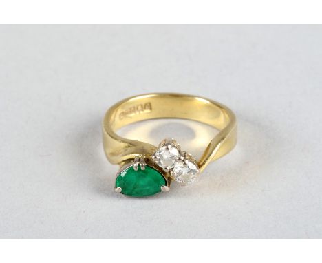 18 carat gold ring with an emerald and two brilliant cut diamonds 