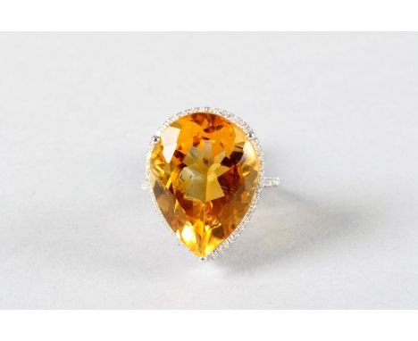 14K white gold and diamond ring set with a pear shaped citrine, approx. 13 carat, diamond weight approx. 0.5 carats 