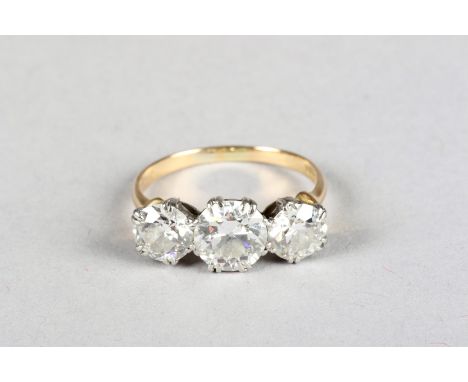 Ladies 18 carat yellow gold three stone diamond ring, centre stone 1.5 carat brilliant cut diamond flanked either side by a s