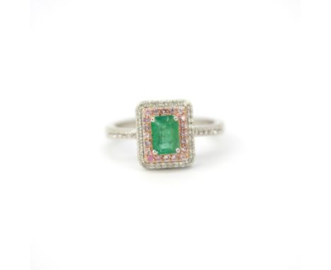 A 925 silver ring set with an emerald surrounded by pink and white diamonds, (R ).