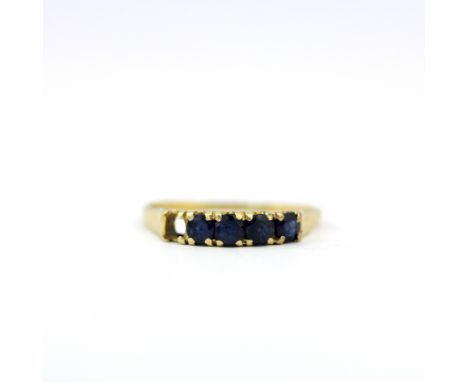 A yellow metal (tested minimum 9ct gold) ring set with round cut sapphires, one sapphire missing, (R ).