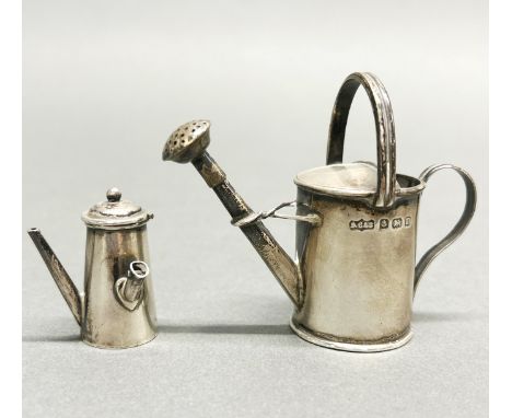 A miniature hallmarked silver watering can, H. 6.5cm, together with a miniature coffee pot (without handle).