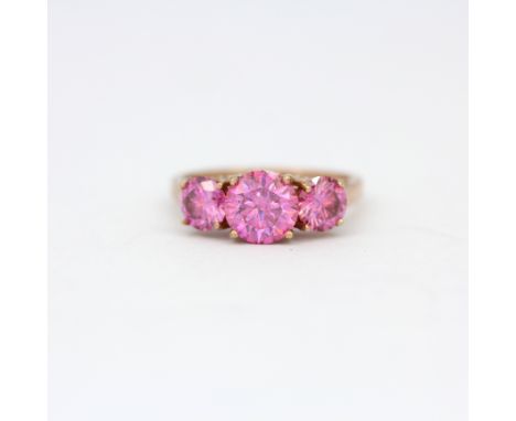 A rose gilt on silver ring set with large round cut pink moissanite and small diamonds, (R.5).