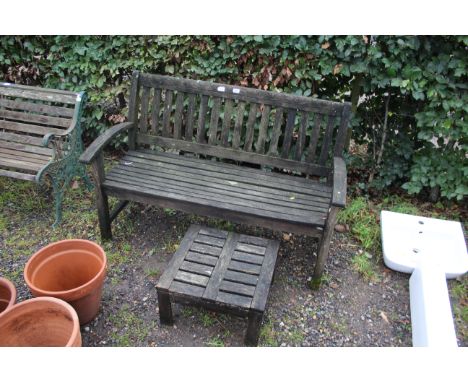 A wooden two seater garden bench and a wooden side table