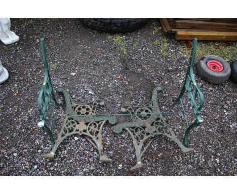 A green painted cast iron bench frame and a pair of green painted cast iron bench ends