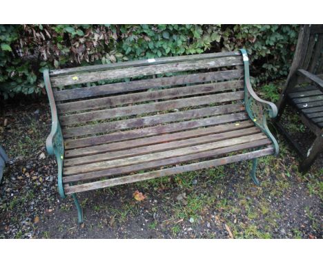 An ornate metal and wooden slatted garden bench 