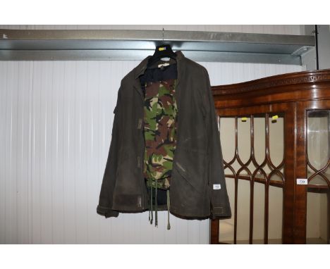 A Quicksilver beating wax coat, size M, with a pair of camouflage trousers