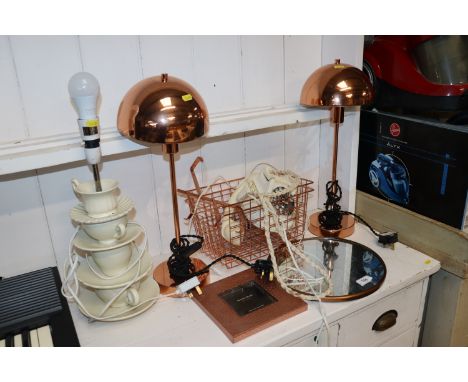 A pair of copper table lamps, circular framed wall mirror, photo frame, baskets, rotary telephone and a teacup table lamp