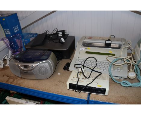 A Brother typewriter and a radio alarm clock together with a Phillips radio cassette deck and an HP printer